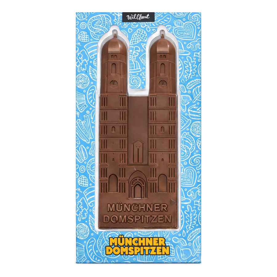Verpackung der Münchner Domspitzen von Wildbach mit der Frauenkirche als Vollmilchschokolade-Relieftafel vor blauem Bayern-Muster