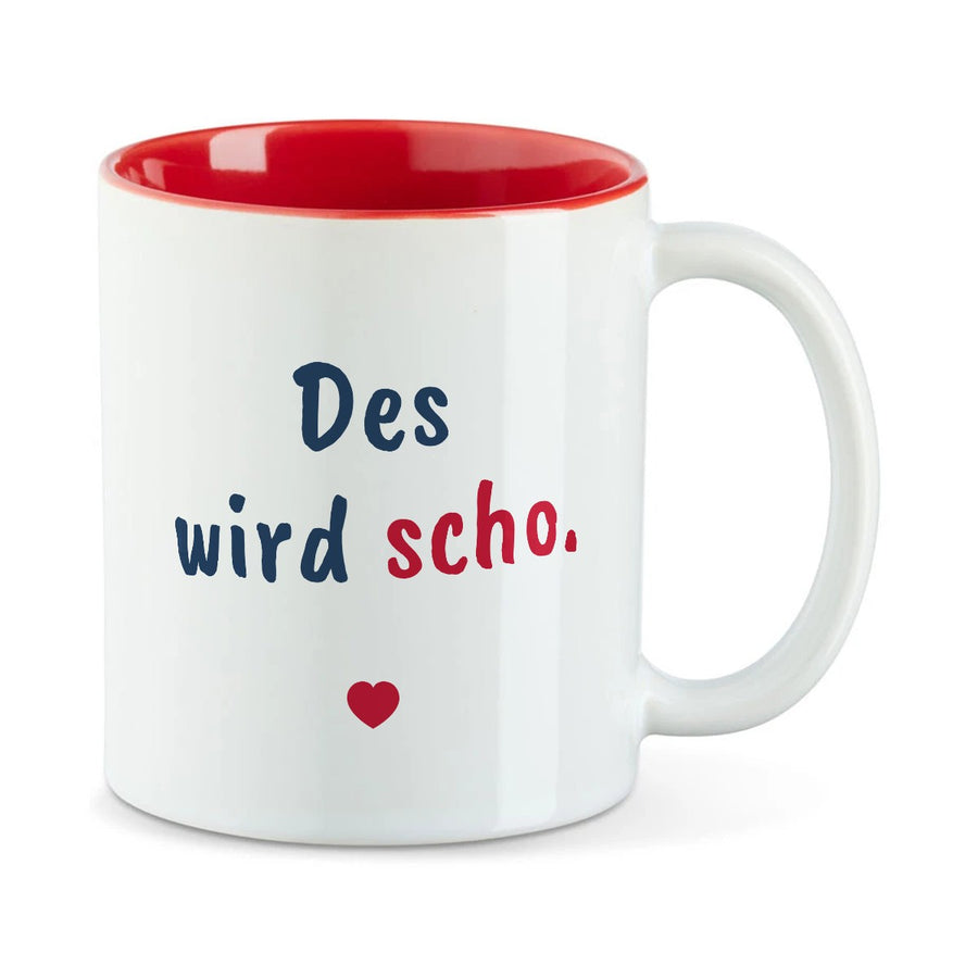 Weiße Tasse mit roter Innenseite und dem bairischen Spruch „Des wird scho.“ in Pinselschrift.