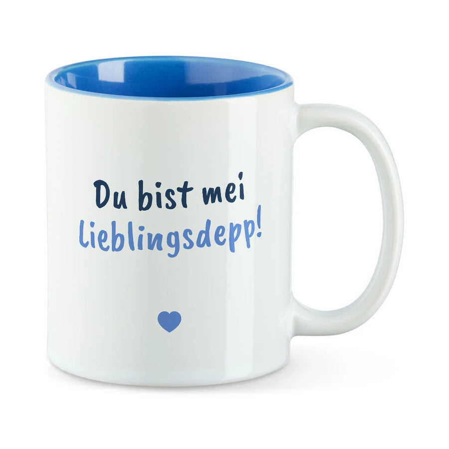 Weiße Tasse mit blauer Innenseite und dem bairischen Spruch „Du bist mei Lieblingsdepp!“ in Pinselschrift.