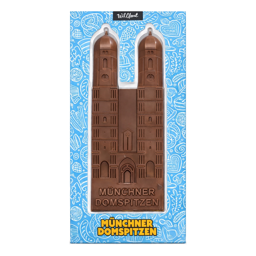 Verpackung der Münchner Domspitzen von Wildbach mit der Frauenkirche als Vollmilchschokolade-Relieftafel vor blauem Bayern-Muster