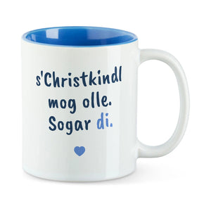 Weiße Tasse mit blauer Innenseite und dem bairischen Spruch „s'Christkindl mog olle. Sogar di.“ in Pinselschrift.