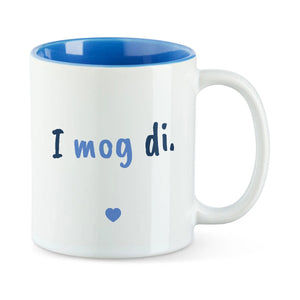 Weiße Tasse mit blauer Innenseite und dem bairischen Spruch „I mog di.“ in Pinselschrift.