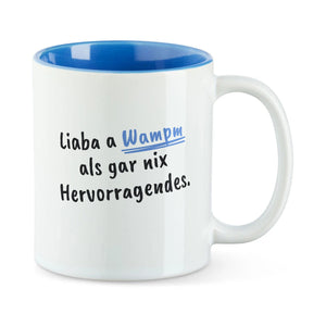 Weiße Tasse mit blauer Innenseite und dem bairischen Spruch „Liaba a Wampm als gar nix Hervorragendes.“ in Pinselschrift.