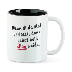 Weiße Tasse mit schwarzer Innenseite und dem bairischen Spruch „Wenn di da Mut verlosst, dann gehst hoid alloa weida.“ in Pinselschrift.