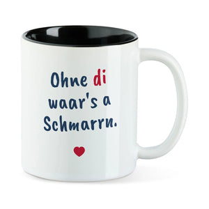 Weiße Tasse mit schwarzer Innenseite und dem bairischen Spruch „Ohne di waar's a Schmarrn.“ in Pinselschrift.