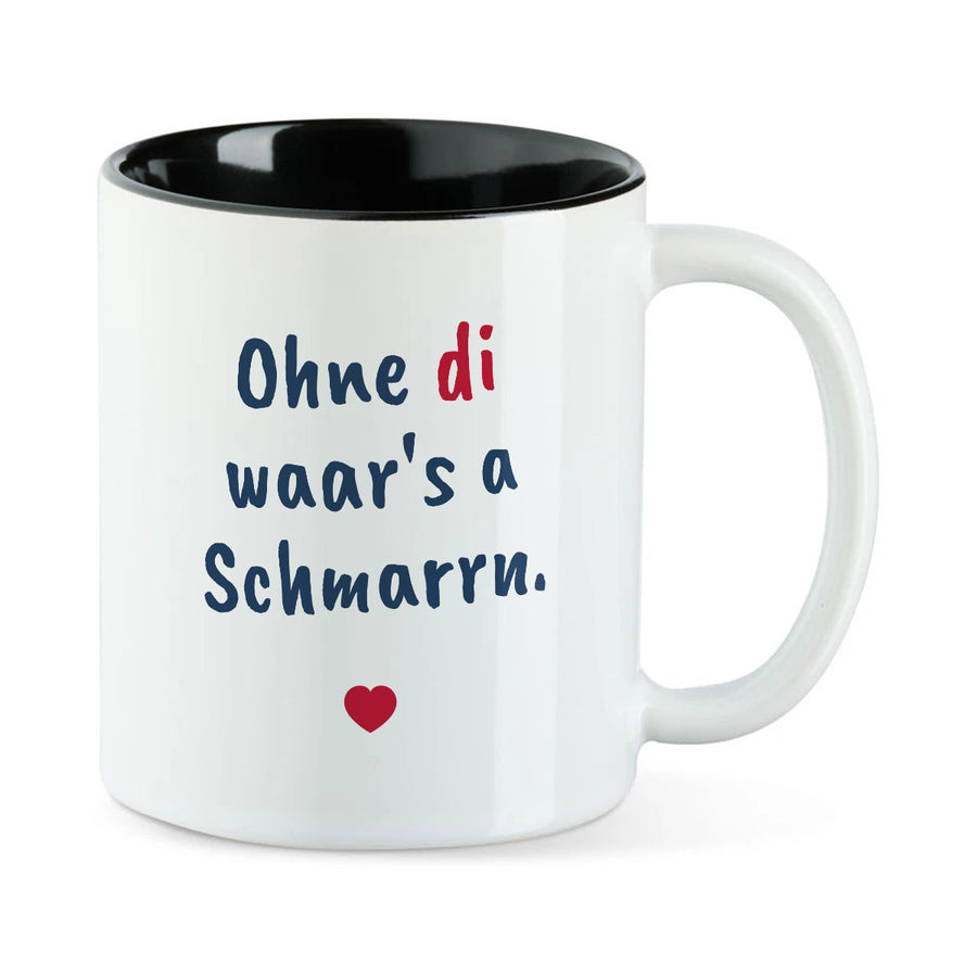 Weiße Tasse mit schwarzer Innenseite und dem bairischen Spruch „Ohne di waar's a Schmarrn.“ in Pinselschrift.