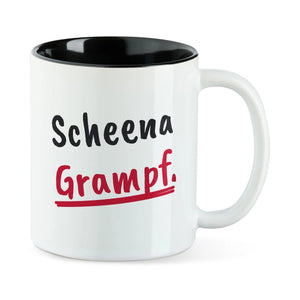 Weiße Tasse mit schwarzer Innenseite und dem bairischen Spruch „Scheena Grampf.“ in Pinselschrift.