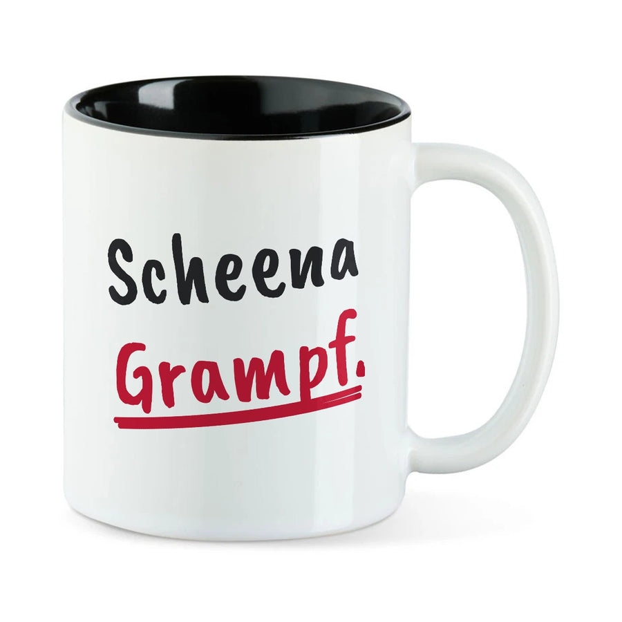 Weiße Tasse mit schwarzer Innenseite und dem bairischen Spruch „Scheena Grampf.“ in Pinselschrift.