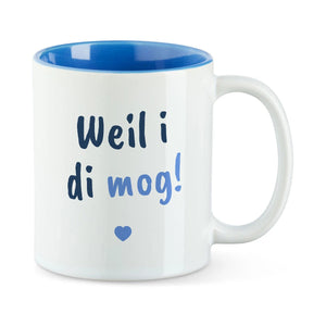 Weiße Tasse mit blauer Innenseite und dem bairischen Spruch „Weil i di mog!“ in Pinselschrift.